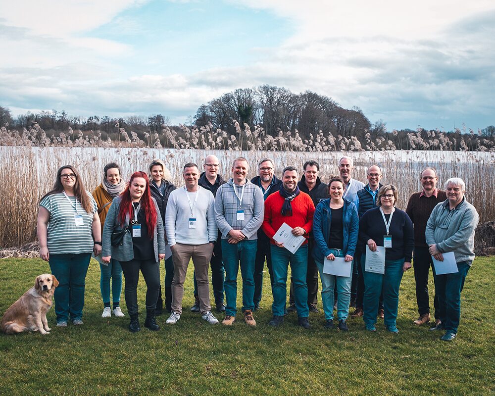 Gruppenfoto der Teilnehmenden und Dozierenden mit ihren Zertifikaten im Freien